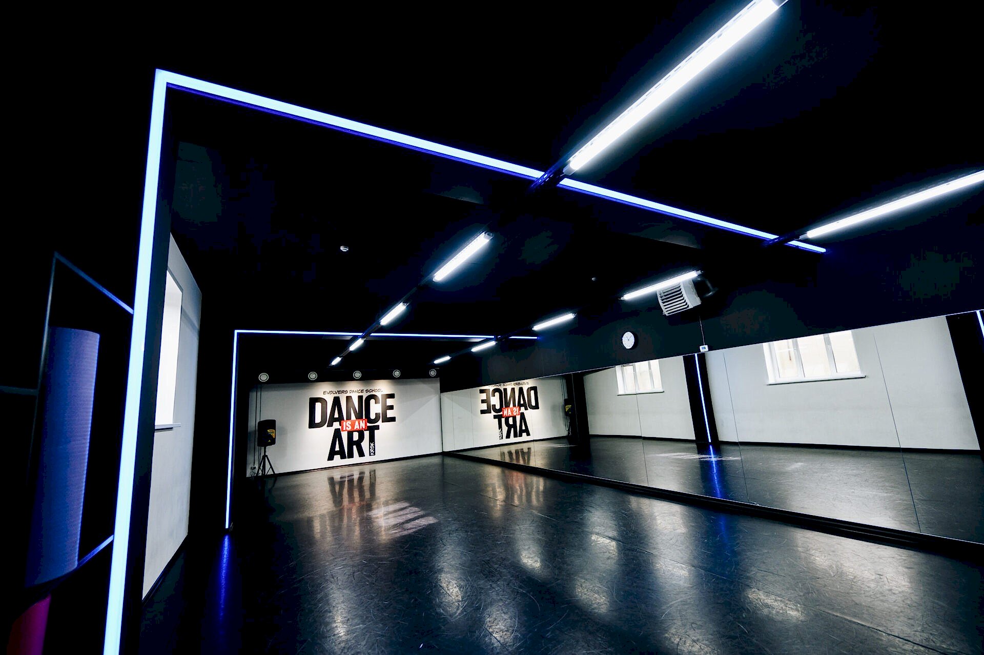 Современная танцевальная студия с зеркалами и неоновым освещением, надпись Dance is an art.